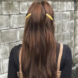 Set of two yellow oval acetate hair clips in a minimalist leaf-inspired willow design