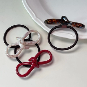 Three-piece hair ties set with tortoiseshell and marble acetate twist charms on black elastic