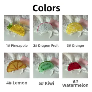 Six fruit-shaped acetate hair claws including pineapple dragon fruit orange lemon and kiwi