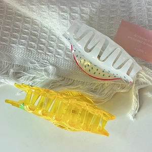 Detail of acrylic fruit hair claws featuring watermelon and lemon patterns for long hair