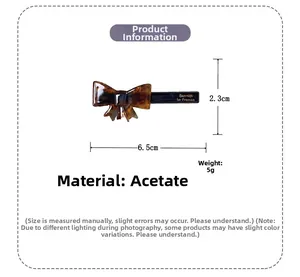 Macro detail of tortoiseshell acetate bow clip with dimensions 6.5cm and Barrette engraving