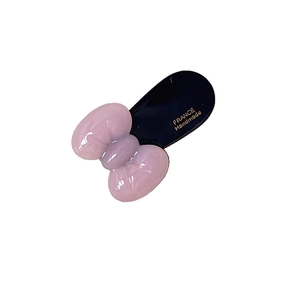 Süße rosa transparente Schleifen-Haarspange mit goldenem Text und schwarzem Acetat