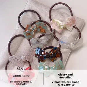 Elegant cellulose acetate bow scrunchies in various marble and tortoiseshell patterns