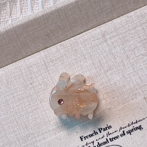Detail view of a cute rabbit acetate hair claw clip with a sparkling rhinestone eye detail