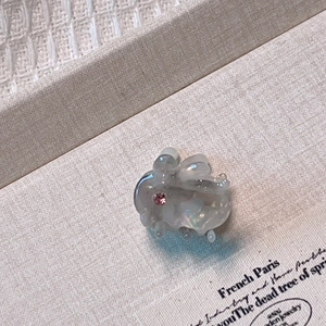 Macro shot of an iridescent rabbit hair clip with a pink zircon stone inlay detail