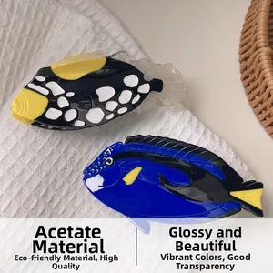 Detailed close-up of handmade acetate fish hair claws with colorful patterns and glossy finish