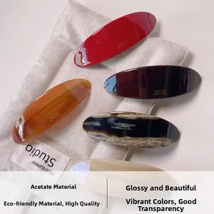 Detailed close-up of acetate hair barrettes in amber and marble patterns