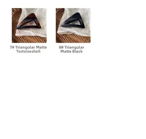 Close-up of tortoise shell and matte black triangle hair claws with frosted finish texture