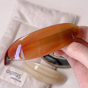Macro detail of amber tortoiseshell acetate barrette with elegant La France lettering