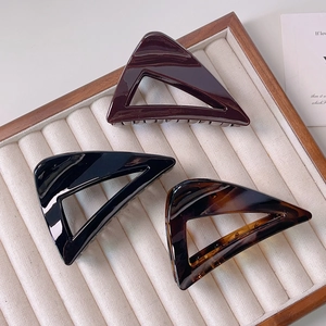 Three triangular acrylic claw clips in wine red, black and tortoiseshell patterns