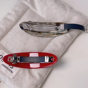 Minimalist acetate hair clips in red and marble patterns with secure metal spring buckles