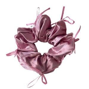 Pink satin scrunchie with delicate ribbon bows in a French ballet aesthetic style
