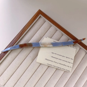 Detail of marble pattern acetate hair stick with France Handmade engraving on wood tray
