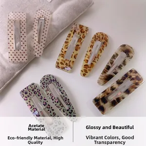 Detail view of acetate leopard print and polka dot hair clips with glossy finish