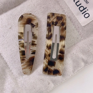 Detail view of acetate leopard print hair clips set with water drop and rectangle shapes