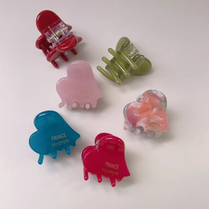 Detailed set of six small heart-shaped hair claws in various vibrant colors and finishes