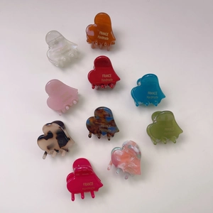 Elegant heart-shaped acetate hair claw clips in various colors with a polished finish