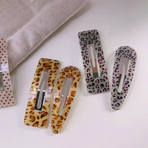 Leopard print and polka dot hair clips in rectangular and teardrop shapes for women