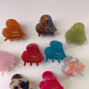 Set of multi-colored acetate heart hair clips including amber and marble patterns