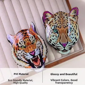 Detail shot of acrylic leopard and tiger claw clips showing glossy PVC finish and patterns