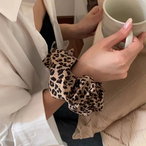 Leopard print oversized scrunchie on wrist for casual hairstyling and fashion wear