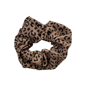 Classic leopard print scrunchie made of soft fabric for versatile ponytail styling