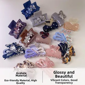 Close-up of colorful acetate hair clips with rhinestones in heart and butterfly shapes