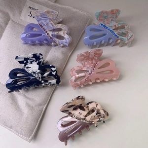 Set of five acetate hair claw clips with marble texture and rhinestones for high ponytails