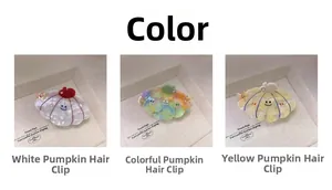 Detail view of acetate pumpkin hair claw clips with pearlescent finish and smiley face