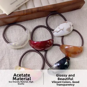 Detailed view of assorted oval acetate hair ties set on high-elastic brown bands