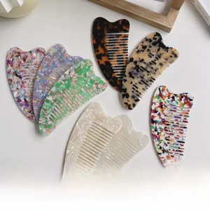 Detail of heart-shaped cellulose acetate combs in various marble and tortoiseshell patterns