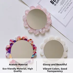 Macro detail of floral acetate pocket mirrors in pink, marbled, and white finishes
