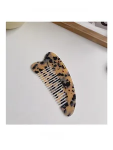 Detailed view of large anti-static hair comb featuring classic tortoiseshell acetate patterns