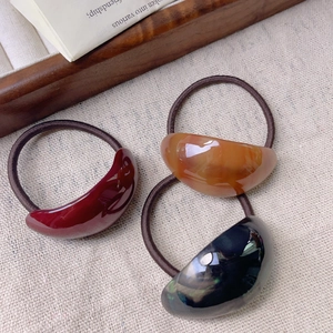 Three-piece set of elegant acetate oval hair ties with amber and marble textures