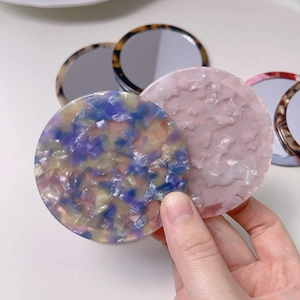 Portable round acetate hand mirror with blue-pink marble pattern and smooth edges