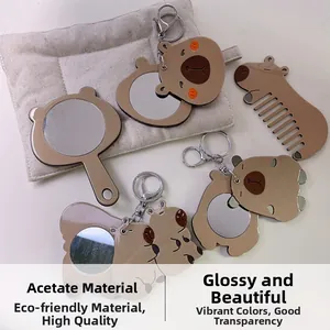 Detailed macro view of eco-friendly acetate capybara mirror and comb set with amber texture