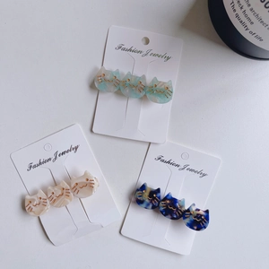 Three-piece French acetate cat hair clips set in leopard and cream patterns with display card
