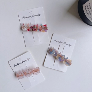 French acetate cat hair clips with marble texture and leopard print patterns on a display card