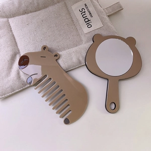 Cute Capybara brown hair comb and bear-shaped vanity mirror set on a beige mat