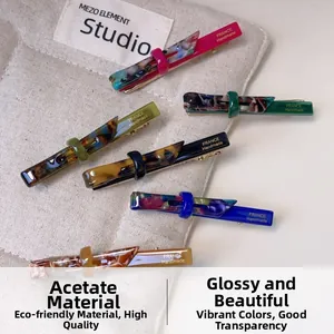 Detailed macro of six acetate hair clips showing France Handmade golden engraving