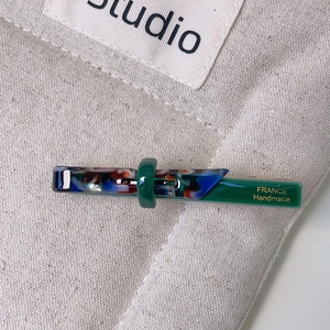 Green acetate bow hair clip with floral marble pattern and France Handmade text detail