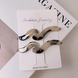 Detail of tortoise shell acetate hair clips set with gold France Handmade lettering