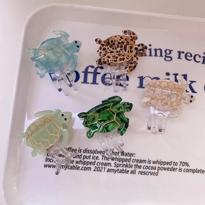Artistic sea turtle acetate hair claws with gold lines and glossy finish in five colors