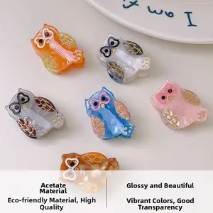 Detailed macro view of six owl-shaped acetate hair clips in various vibrant colors