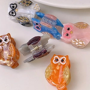 Chic acetate owl hair claws in various marble colors with gold wing details for women