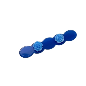 Elegant blue rose hair clip featuring resin flowers and a wavy acetate base