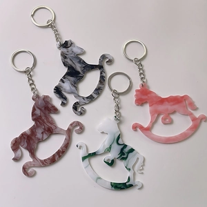 Creative acrylic rocking horse keychains in marble patterns with metallic rings