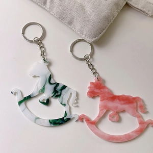 Chic rocking horse keychain set in green and pink marble acrylic with silver metal rings