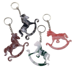 Set of four creative rocking horse keychains in marble textured acrylic for bags
