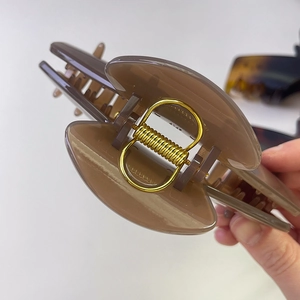 Pinza grande para el pelo en resina marrón con muelle de metal dorado resistente